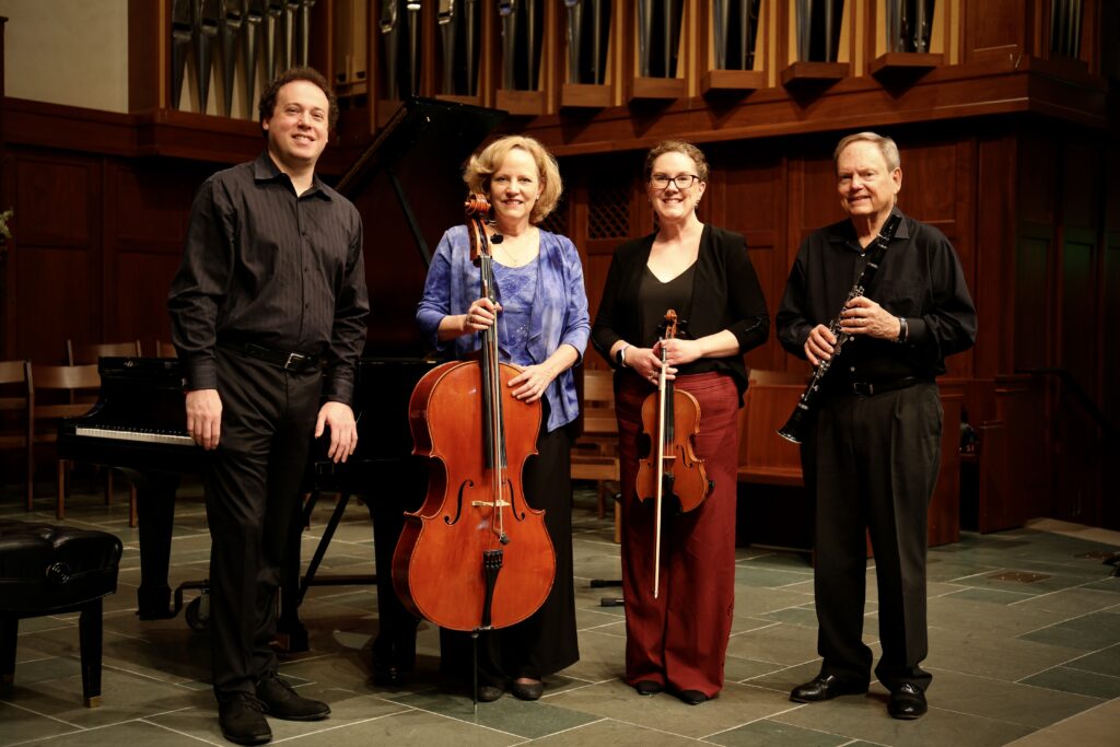 Musicians pose in front of a piano